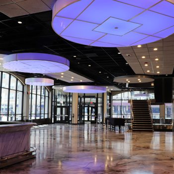 Lumetta was chosen to elegantly illuminate the lobby of the Carteret Performing Arts Center with their dramatic Custom Drum Pendants.